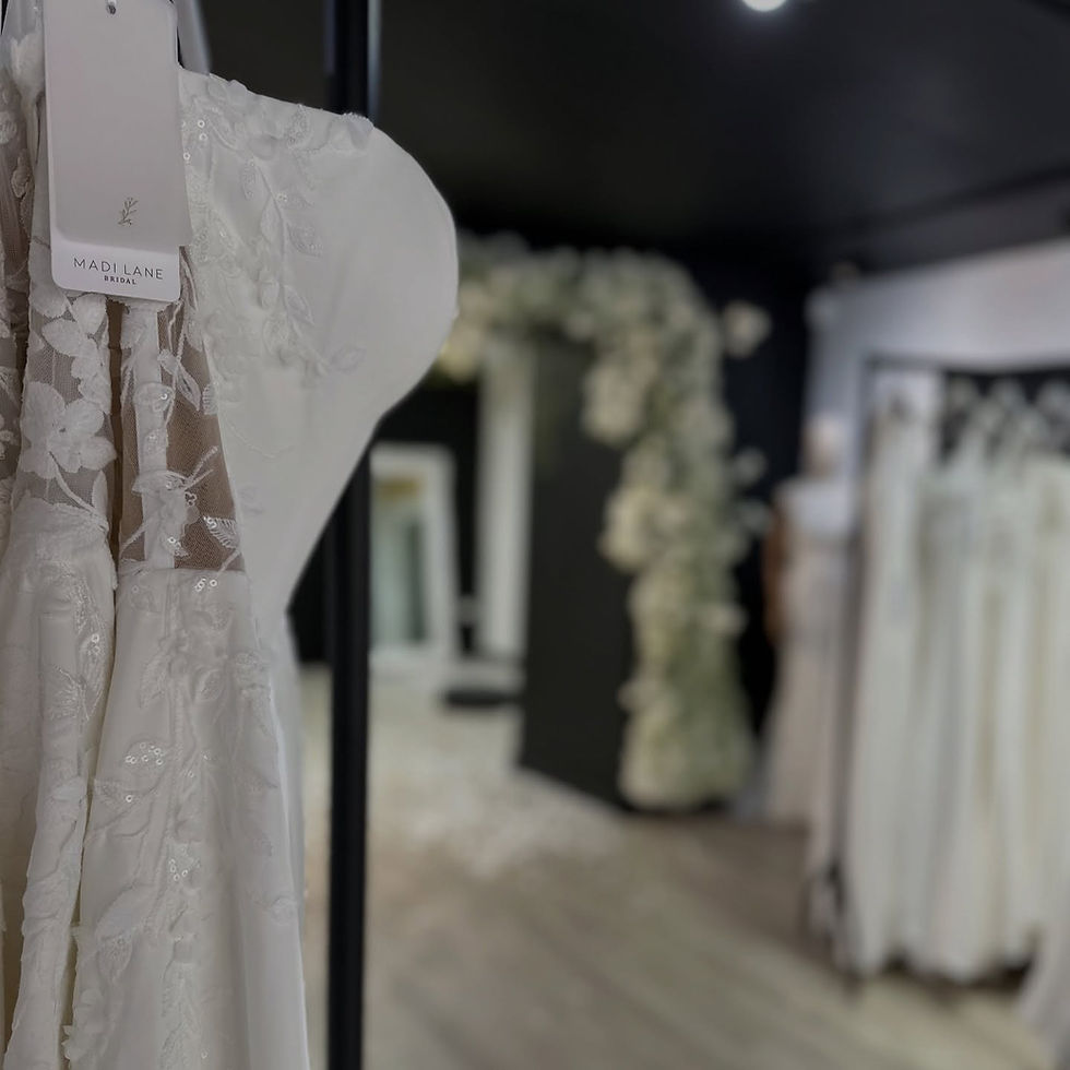 Bride trying on elegant wedding dress at Wedding Belles Love bridal boutique in Stone, Staffordshire