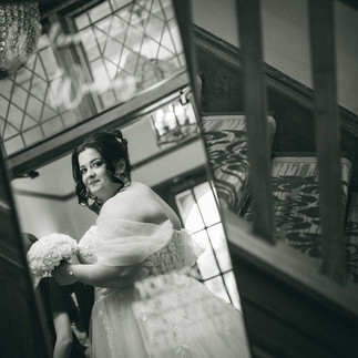 Bride smiling in a romantic Stella York wedding gown with sparkle underlay in Staffordshire.