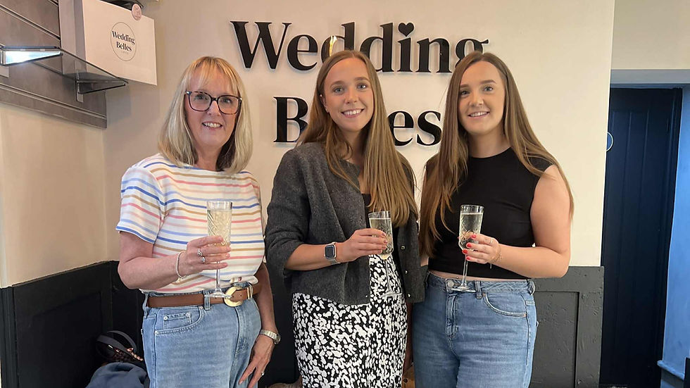Bride beaming as she tries on her dream dress inside Wedding Belles Love boutique

