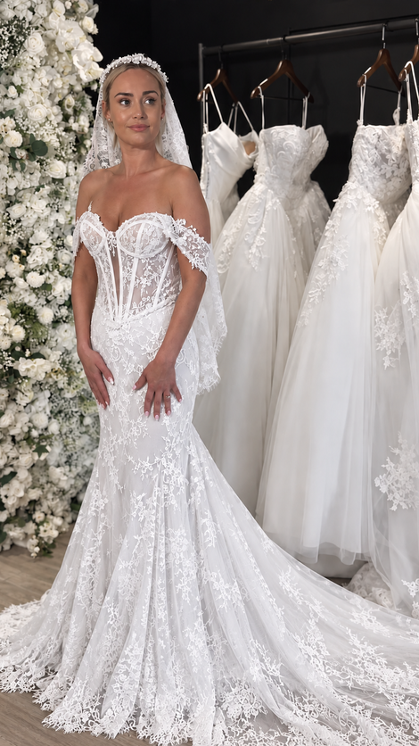 Bride wearing an ivory lace wedding dress at Wedding Belles Love bridal boutique in Staffordshire.