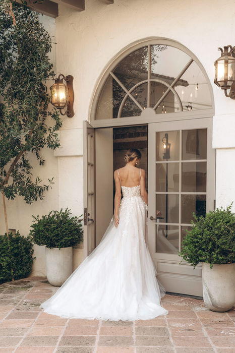 Stella York Style SY8105 ethereal lace and tulle A-line wedding dress with beaded spaghetti straps, sheer square neckline, intricate 3D floral appliqués, and airy layered skirt — petite fit sample available at Wedding Belles Love, Claire Sutton’s size-inclusive bridal boutique in Staffordshire.