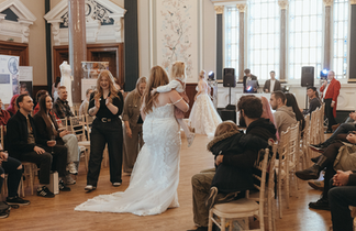 Classic A-line wedding dress with subtle shimmer under the lights.