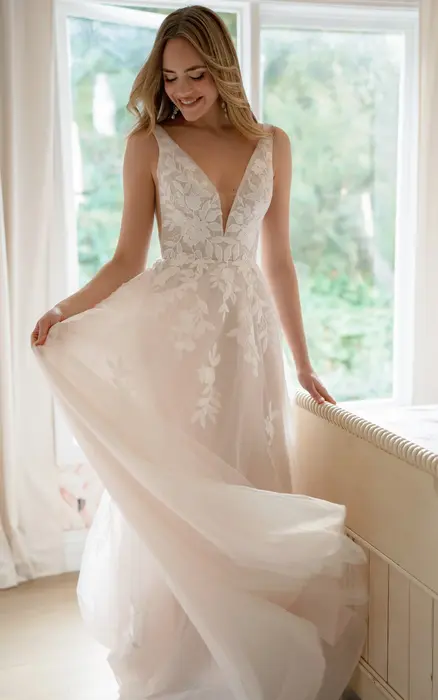 Stella York SY8316 ivory wedding dress size 20 at Wedding Belles Love Stone Staffordshire featuring floral lace appliqués, deep V plunge neckline and flowing A line skirt.