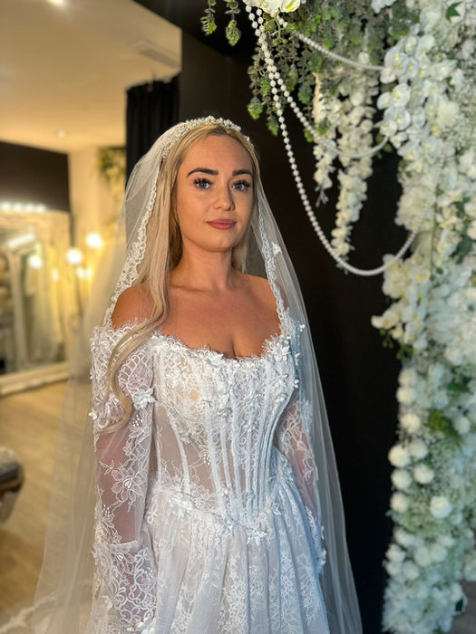 Delphine by Mavery Hugh wedding dress at Wedding Belles Love Staffordshire showcasing delicate Chantilly lace and a full tulle skirt.