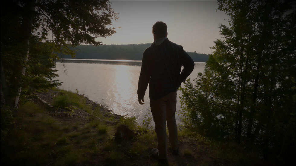 Joshua D. Hinkel looking out over a calm lake