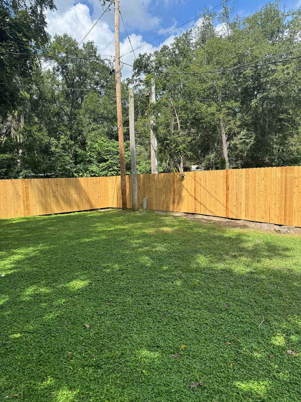 Wood privacy fence installation around residential property in Gainesville.