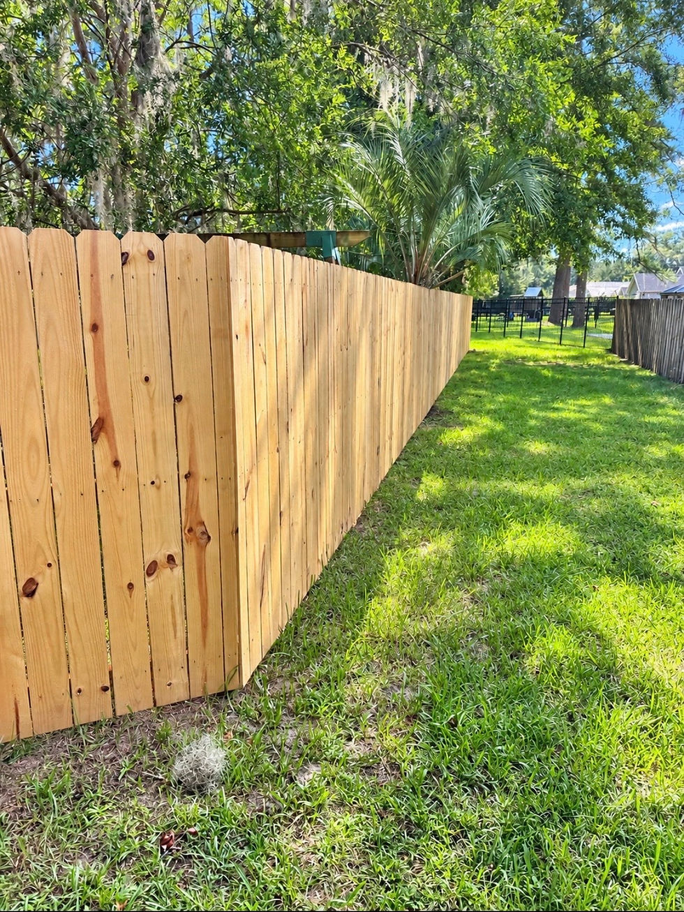 Traditional wood privacy fence installation in North Florida home.