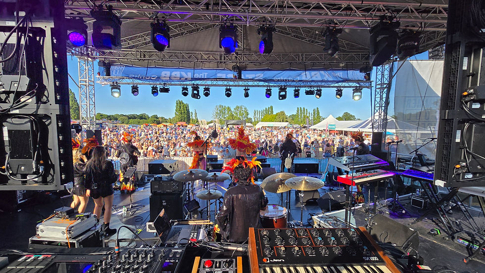 a bright and vibrant energy atmosphere inside an event arena with a band performing on stage