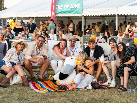 A group of eight people sat on fold out chairs watching the stage at Summer Soul Vibes 2025