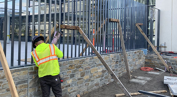 technician installing security fence