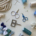 Photo of embroidery scissors in white, silver, and blue.