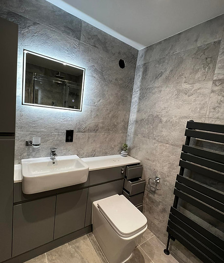 Modern bathroom with sleek fixtures, a spacious shower, elegant tiles, and stylish lighting, creating a clean and relaxing at