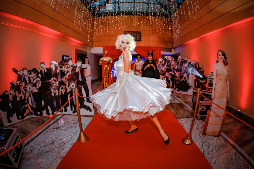 lady standing on red carpet in a pos