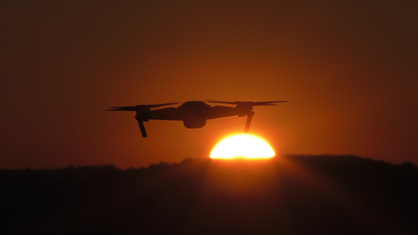 A drone camera in the air and the sun is setting