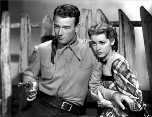 Black and movie scene man holding a gun in hand and girl is with him