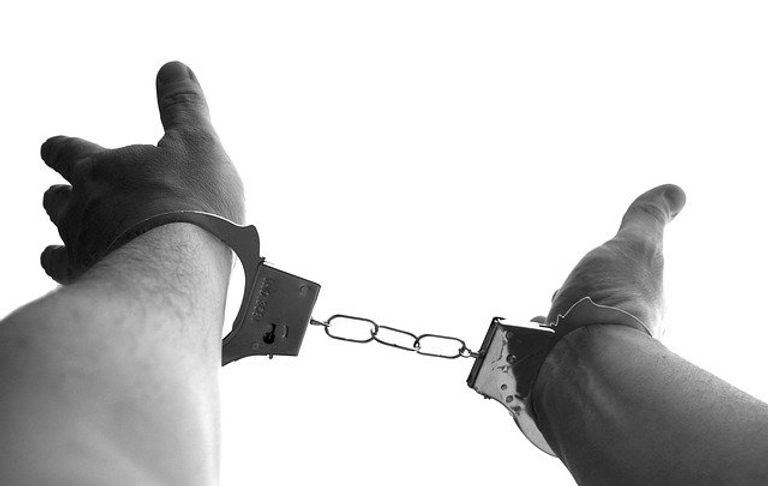 Hands in hand cuffs
