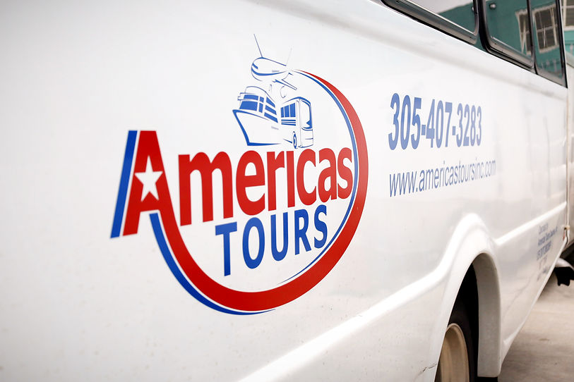 Image of Americas Tours Inc logo on the side of a van vehicle.