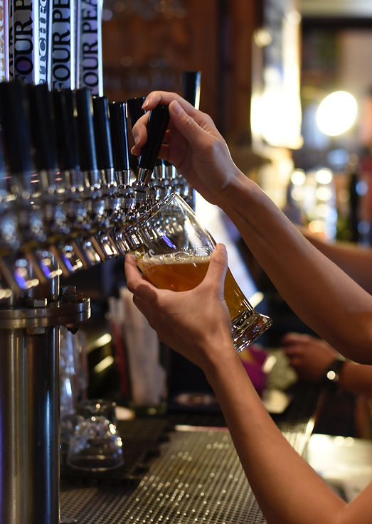 Trinity Beer Club Bartender Pouring Beer