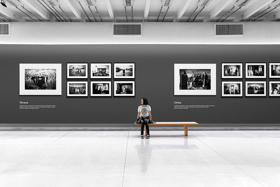 Conceptual exhibition installation of Caryatis by George Tatakis, showing museum presentation of black-and-white photographs exploring Greek cultural heritage and traditional dress.