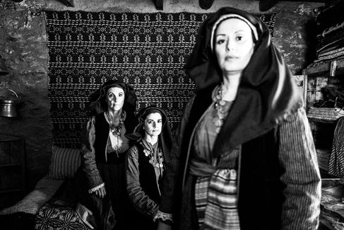 Three women in the traditional costumes of Alagonia, inside the house where Nikitaras was born, in the village of Nedoussa, Peloponnese, Greece