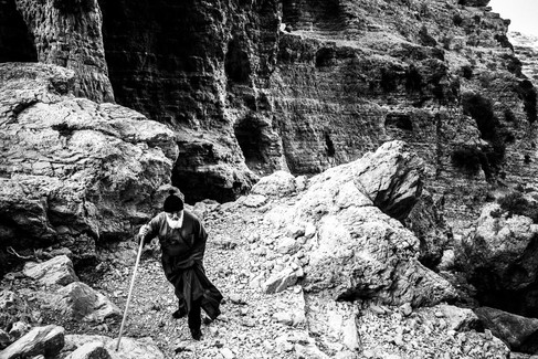 Through the gorge to the festival of St. Zacharias at Argos on the island of Saria, Olympos, Karpathos, Greece. Black and white photography by George Tatakis