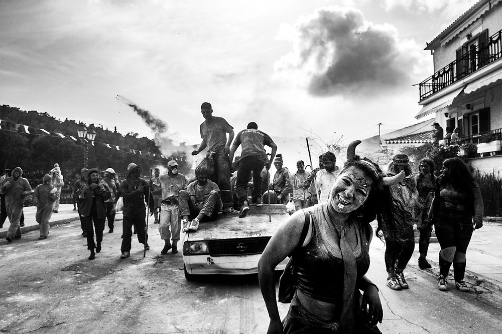 Moving towards the port for the dance to start at the flour wars of Galaxidi, by photographer George Tatakis