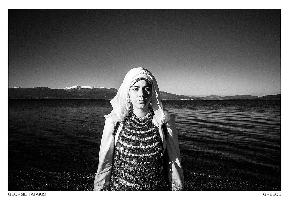 Standing in front of the water, this woman wears the local costume of Atalanti, Lokris, Greece. Black and white photography postcard by George Tatakis, project Caryatis.