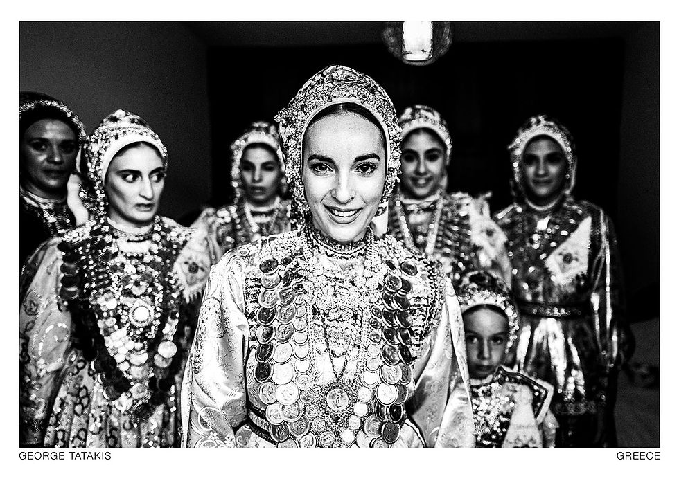 A bride with her friends, exiting her room during her wedding day in Diafani, Olympos, Karpathos, Dodecanese, Greece. Black and white photography postcard by George Tatakis, project Caryatis.
