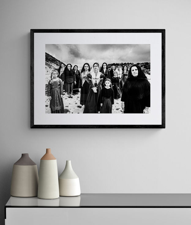 Lefkada generations print framed on a white wall. Black-and-white photography by George Tatakis.