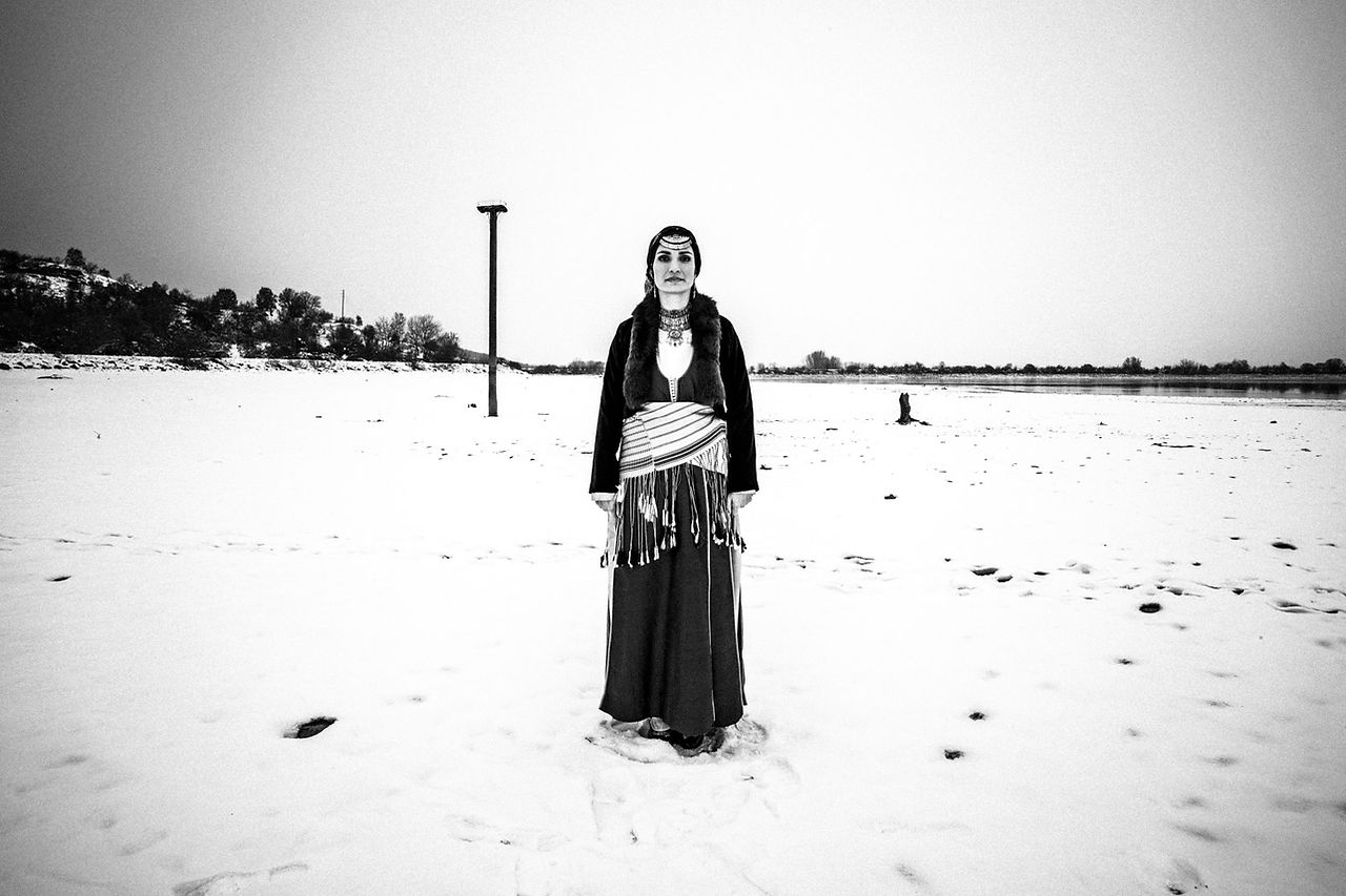 A woman wearing the traditional Pontic dress at lake Kerkini, Macedonia, Greece. Black and white photograph by George Tatakis