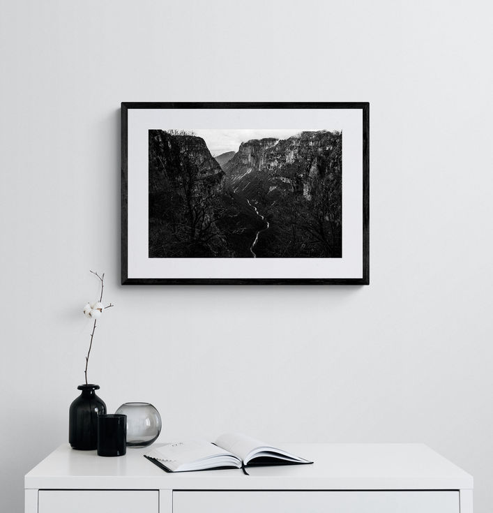 Vikos Gorge print framed on a white wall. Black-and-white photography by George Tatakis.