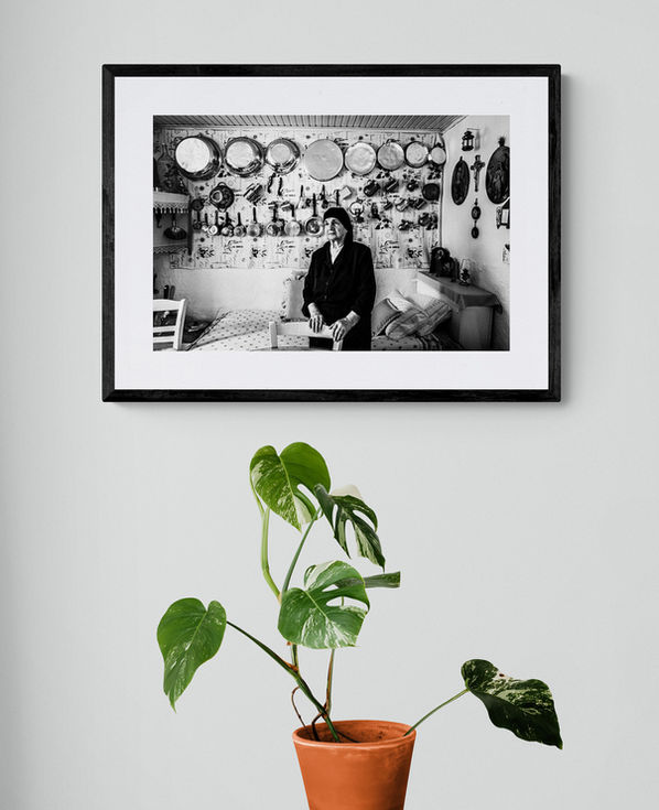 Anogia Kitchen print framed on a white wall. Black-and-white photography by George Tatakis.