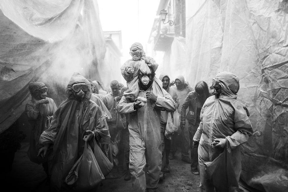 Buildings are covered in nylon to protect them from the flour at the flour wars of Galaxidi, by photographer George Tatakis