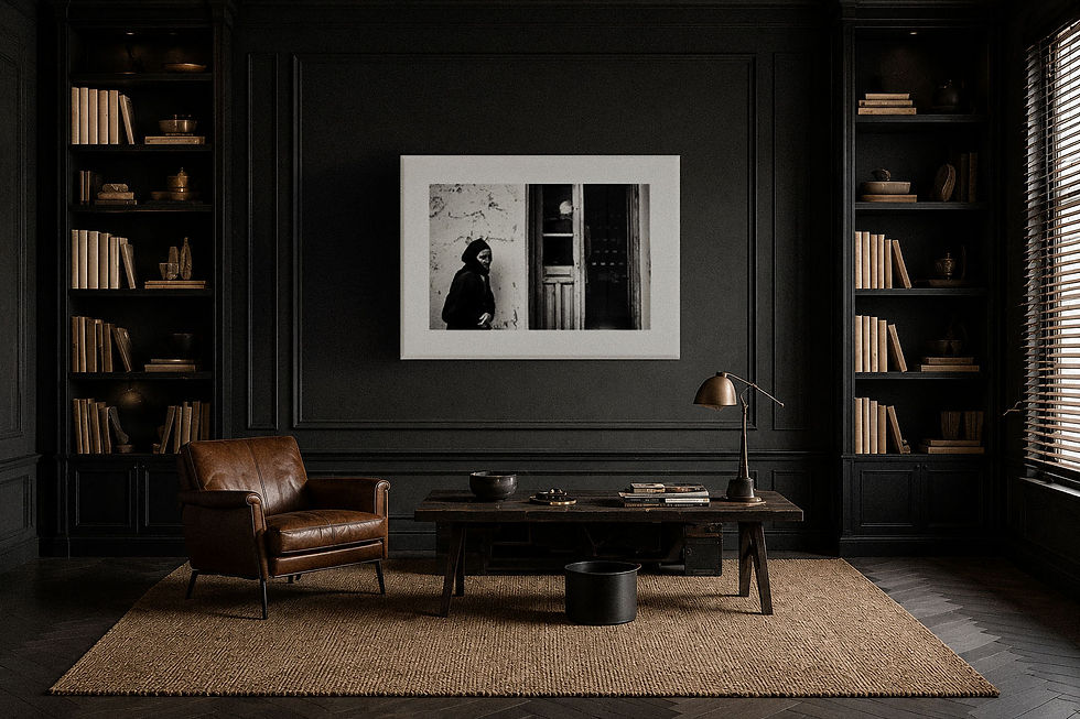 Dark luxury interior featuring a framed black-and-white fine-art photograph displayed within a black architectural wall surrounded by bookshelves, leather furniture, and warm lighting. The scene introduces fine-art photography as a culturally rooted alternative asset within a diversified portfolio.