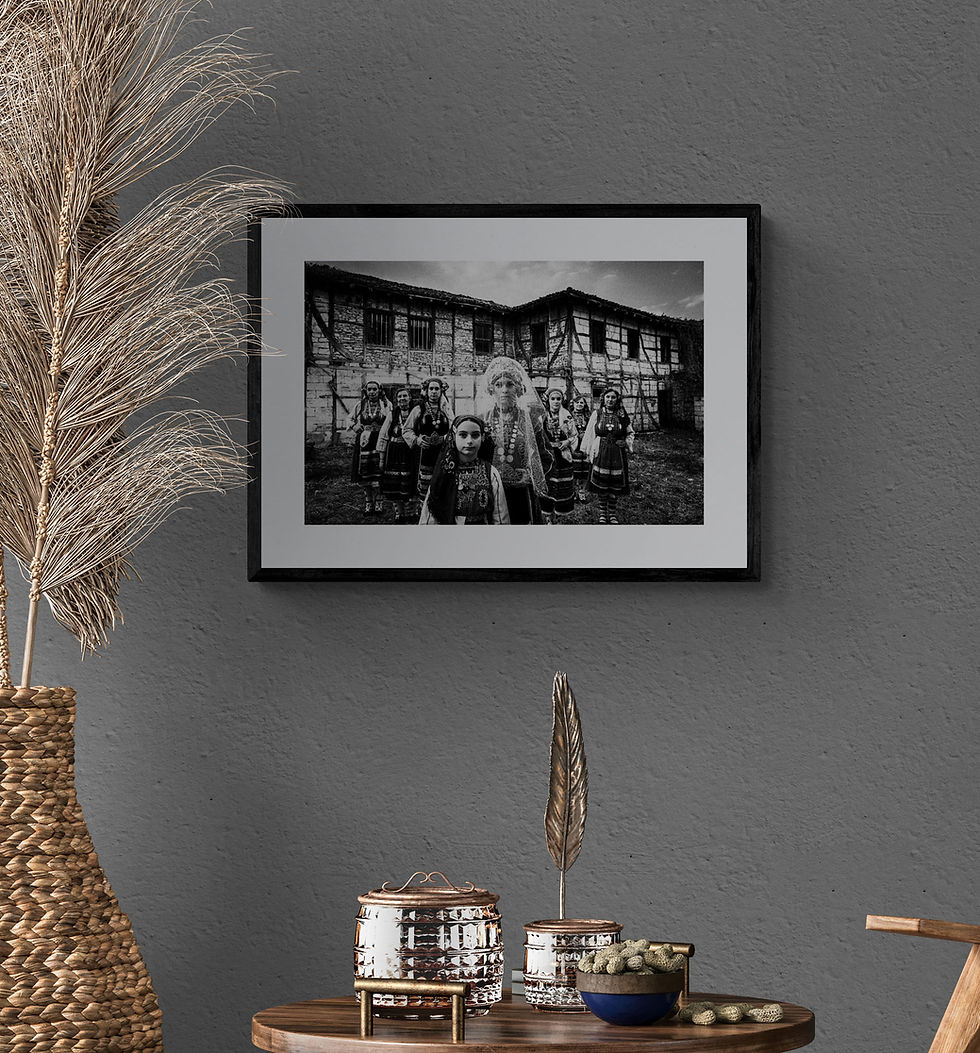 Thumbnail: Bride and Party print framed on a grey wall. Black-and-white photography by George Tatakis.