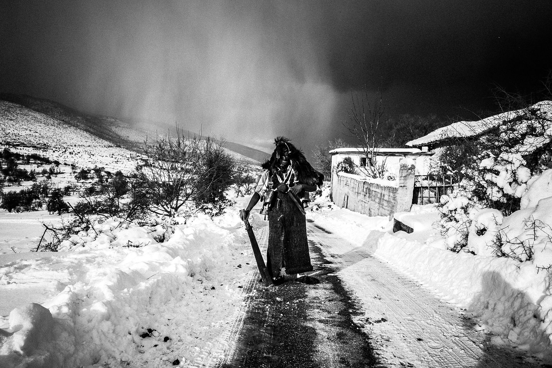 Arapis in the snow, Pagan Christmas customs of Northern Greece, by photographer George Tatakis