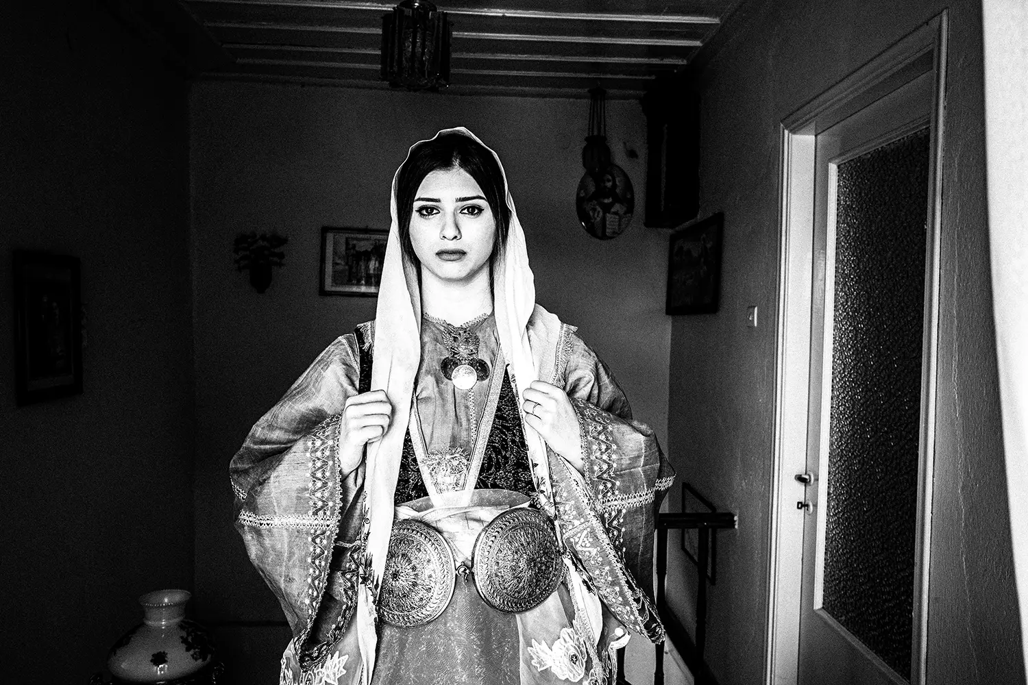 A beautiful girl wearing the traditional bridal dress of Trikeri, Thessaly, Greece. Black and white photography by George Tatakis