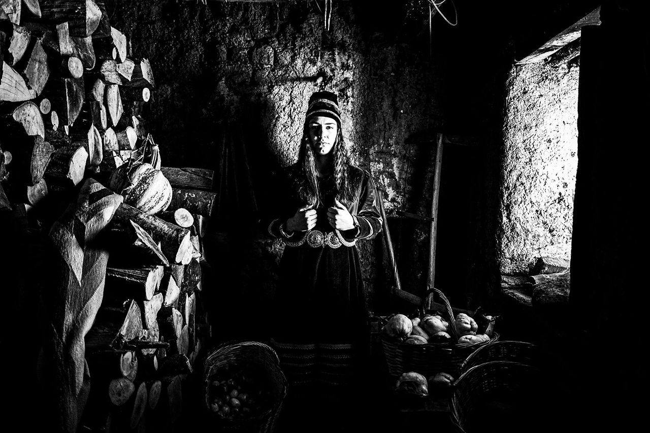 A woman in the traditional attire of Prespes lakes, Macedonia, Greece. Black and white photograph by George Tatakis