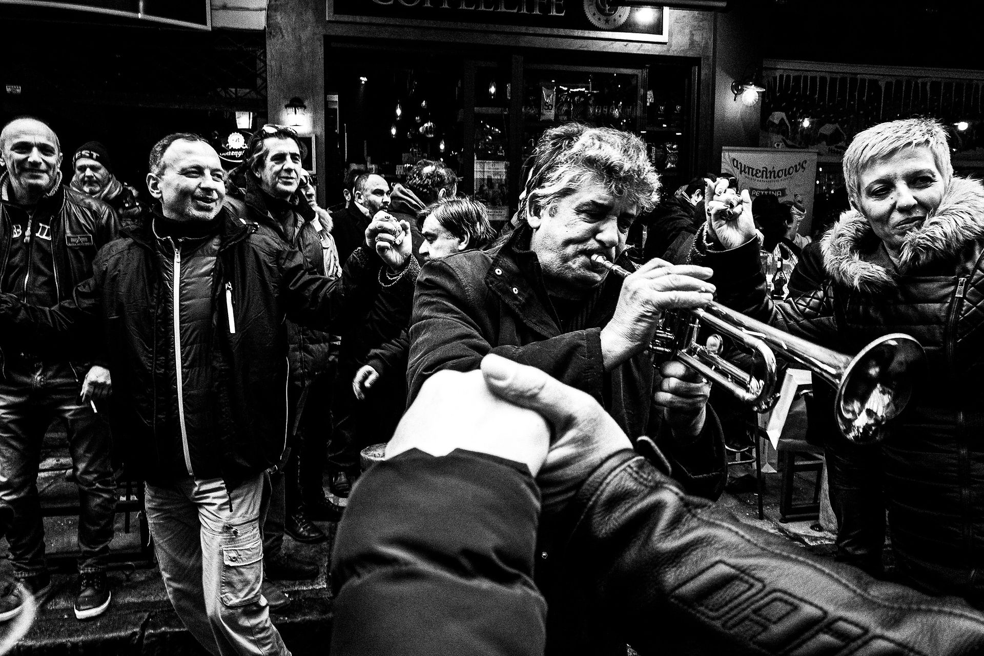 Musicians round Kapani market, Pagan Christmas customs of Northern Greece, by photographer George Tatakis