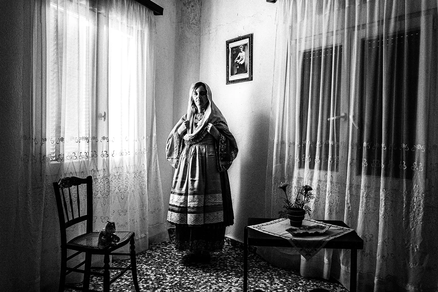 An elderly woman wearing the local folklore dress of Trikeri, Thessaly, Greece. Black and white photography by George Tatakis