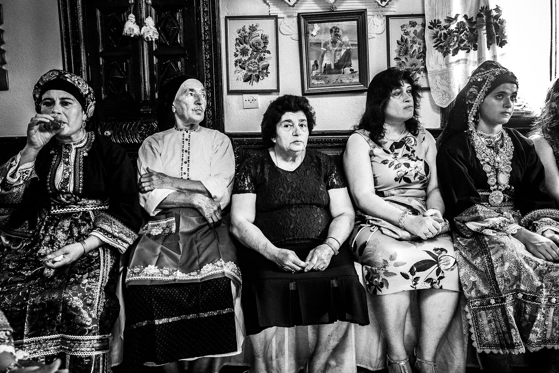 Guests of the family at a wedding in Olympos, Karpathos, Greece. Black and white photography by George Tatakis