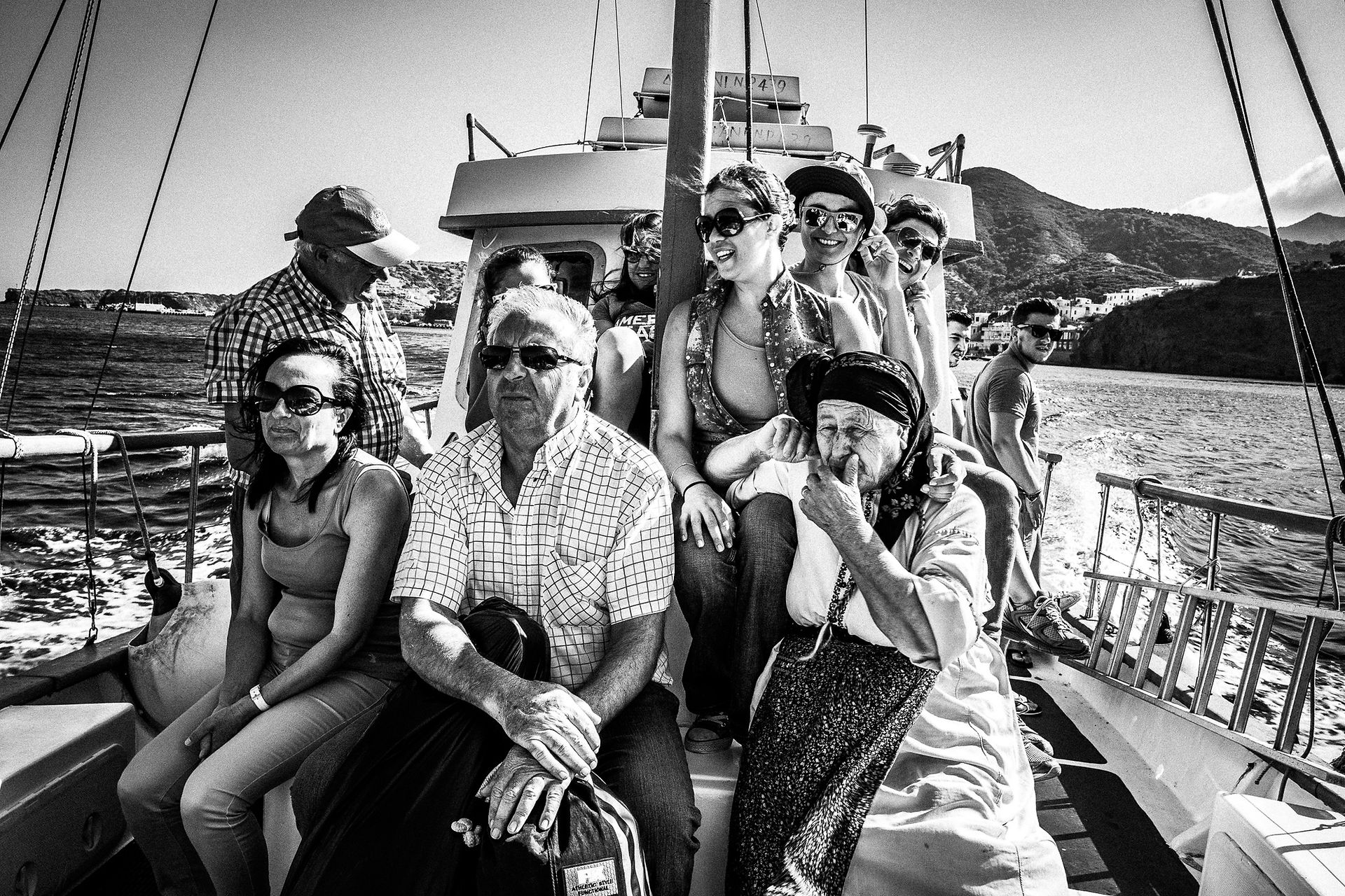 The boat to Saria for the festival of St. Zacharias at Argos on the island of Saria, Olympos, Karpathos, Greece. Black and white photography by George Tatakis