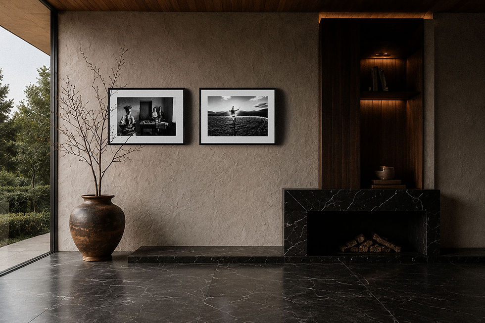 Minimal luxury interior featuring framed black-and-white fine-art photography displayed above a dark marble fireplace. The architectural space combines stone, wood, natural light, and monochrome photographic prints to illustrate how black-and-white photography integrates with contemporary collector interiors.