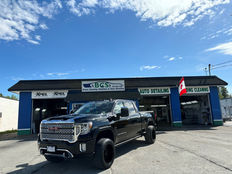 black GMC truck parked infront of bravo cleaning 