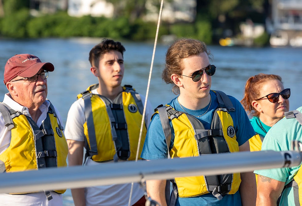 members learning to sail on a dock