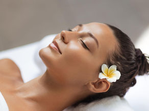 Feeling serene and rejuvenated, a woman enjoys the afterglow of cosmetic acupuncture therapy.