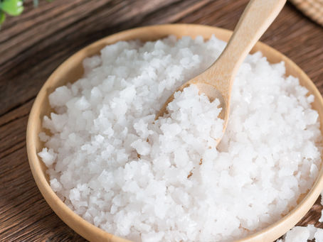sea salt in a wooden bowl with a spoon