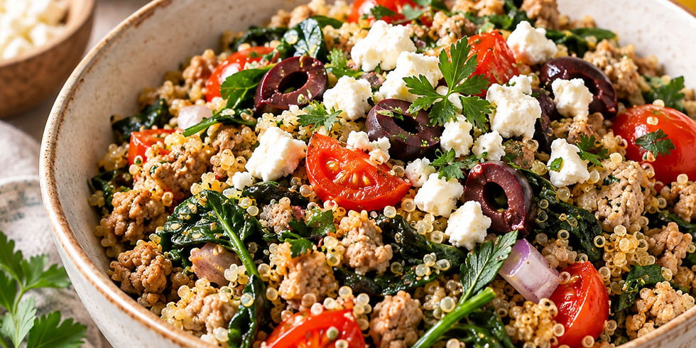 Turkey quinoa bowl with ground turkey, spinach, cherry tomatoes, feta cheese, olives, and fresh herbs.