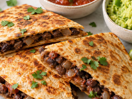 Vegan black bean quesadilla served with salsa, avocado and lime