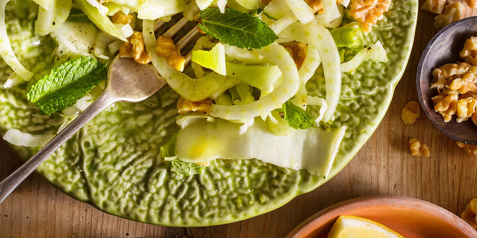 apple walnut fennel salad on a plate with a fork
